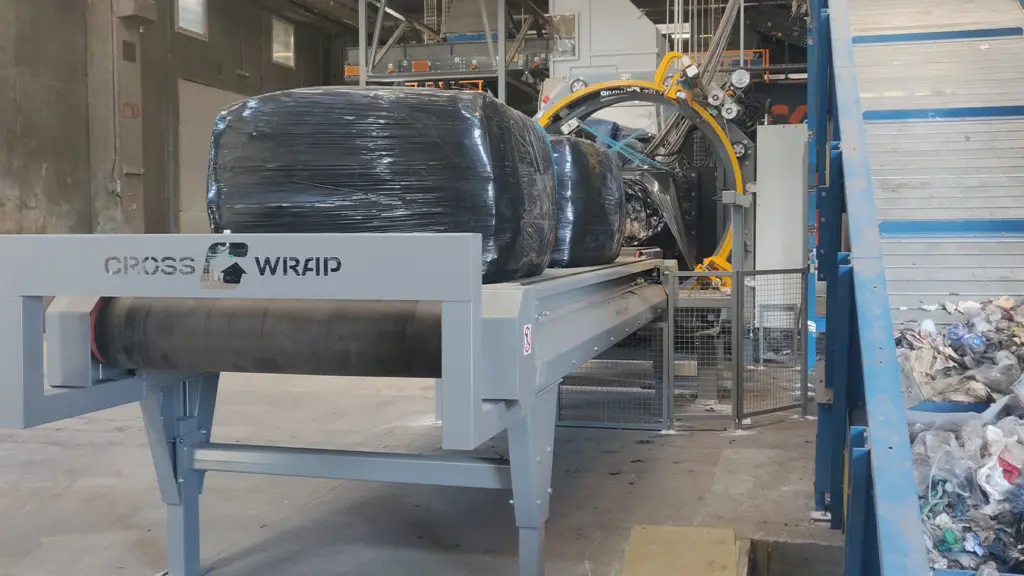 On Image: Bale Wrapper machine wraps paper reject bales neatly